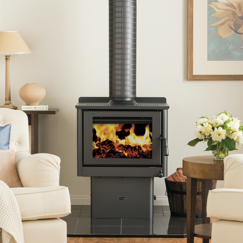 Settler C500 Wood Heater in lounge room with couches and side tables
